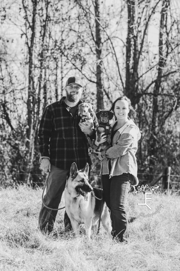 Husband and wife with 2 dachshunds and a german sherpard