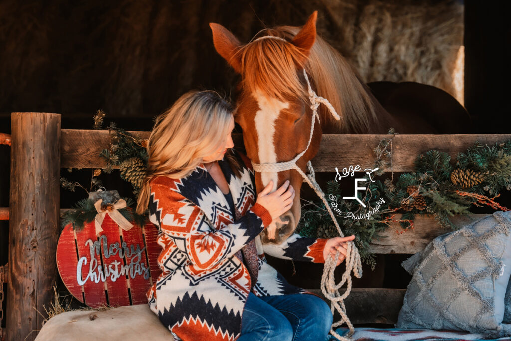 lady sitting in barn with gus