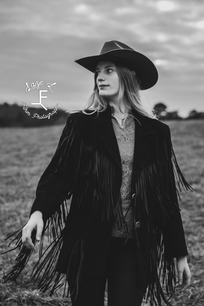 cowgirl in fringe jacket in black and white