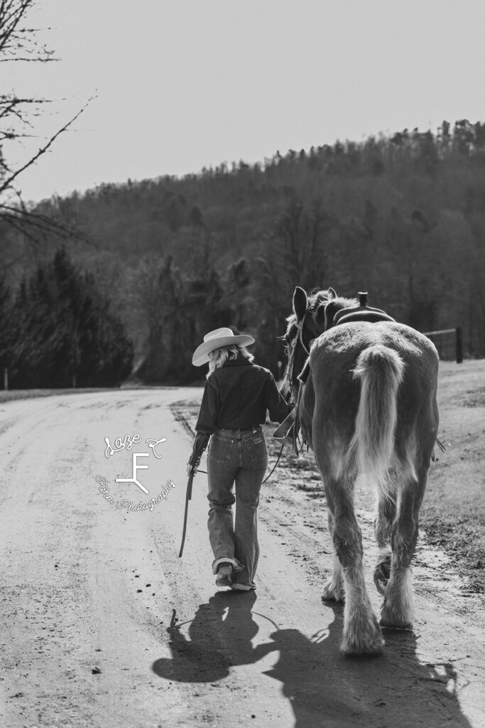 Reid and Dolly walking down dirt road in black and white