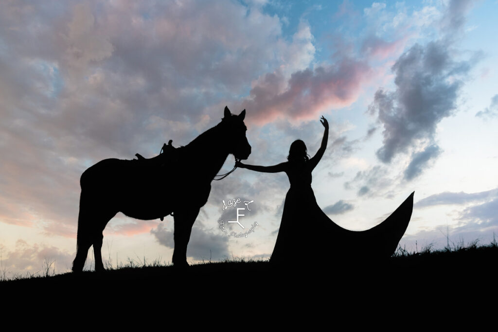 Sunset silhouette of dancer and horse