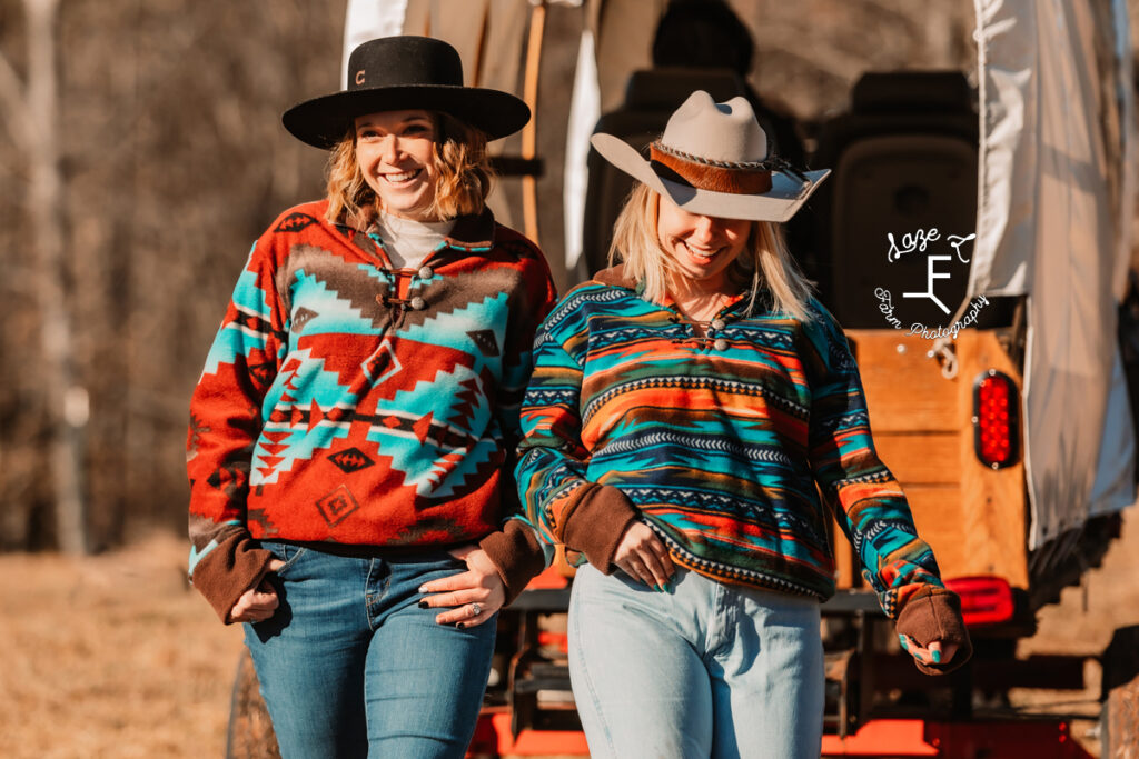 2 models in hates and Aztec print pullovers walking