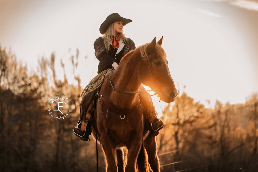 Maria sitting on Gus looking left at sunset