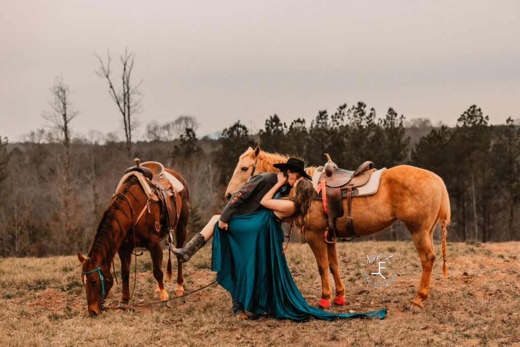 cowboy and wife dipping in front of their horses