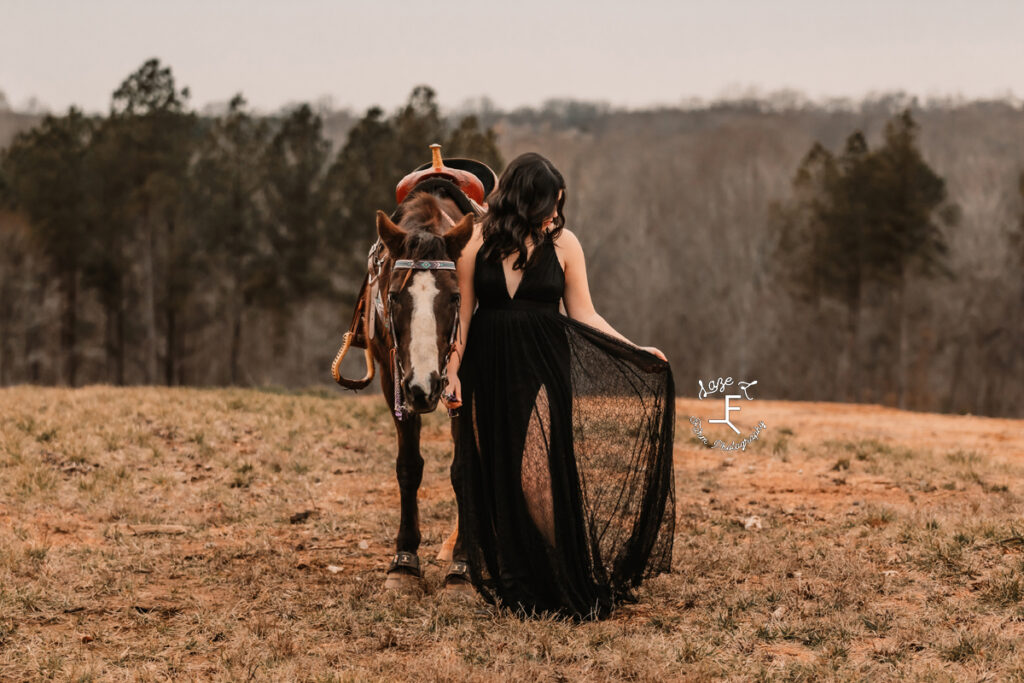 cowgirl in black dress with her mare