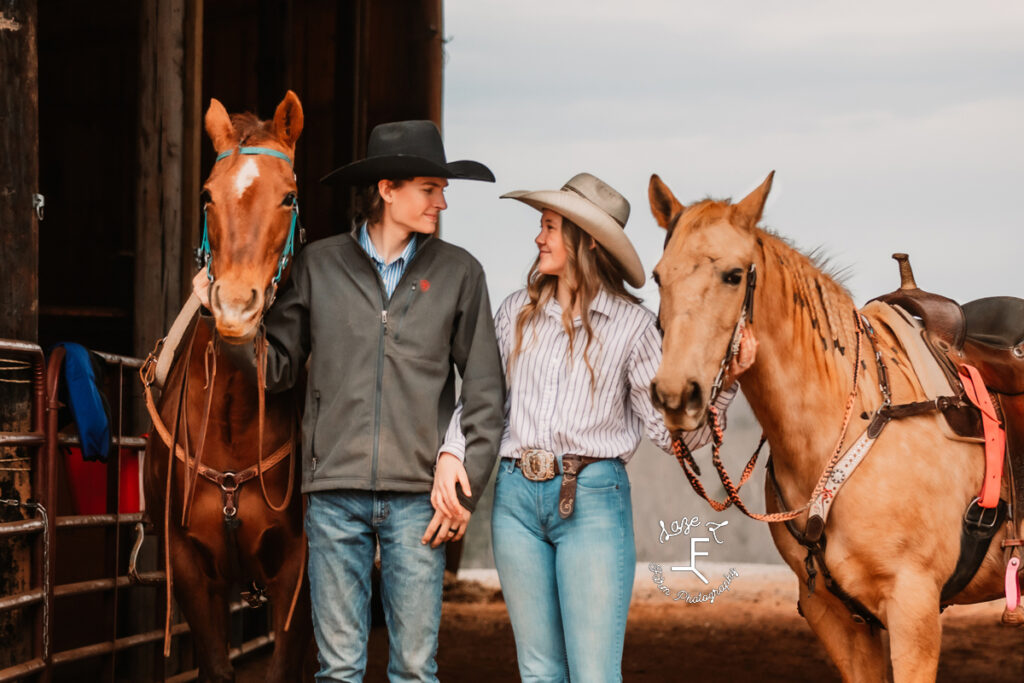 cowboy and cowgirl husband and wife with their horses