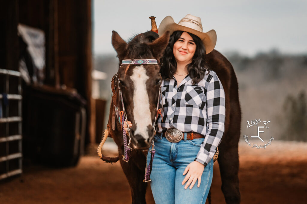 cowgirl with her mare in the barn aisle