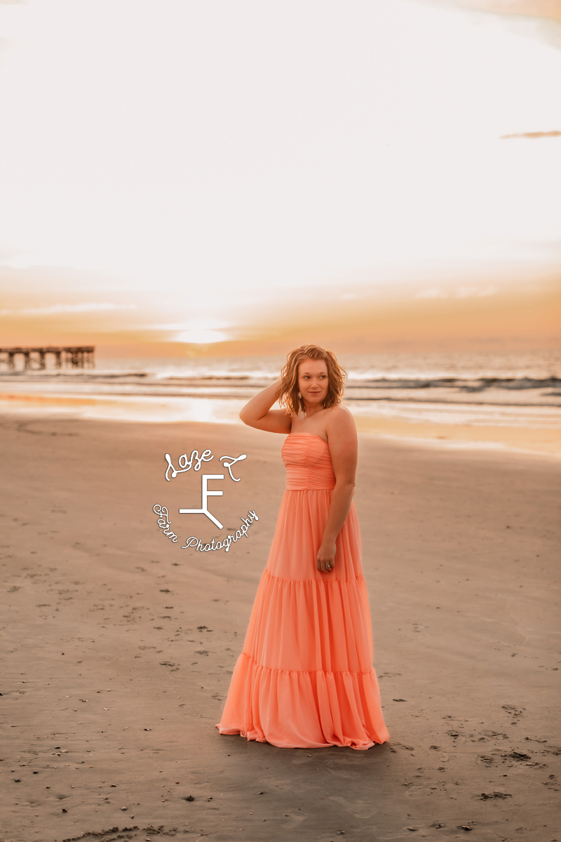 Kayla on the beach in pink dress at sunrise