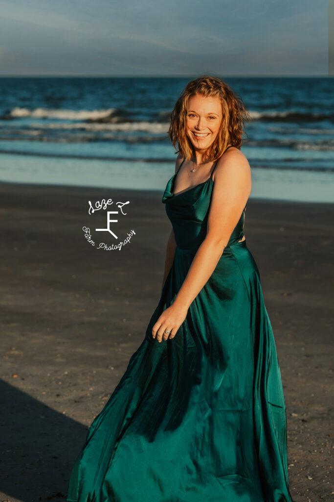 Kayla in front of ocean in green dress