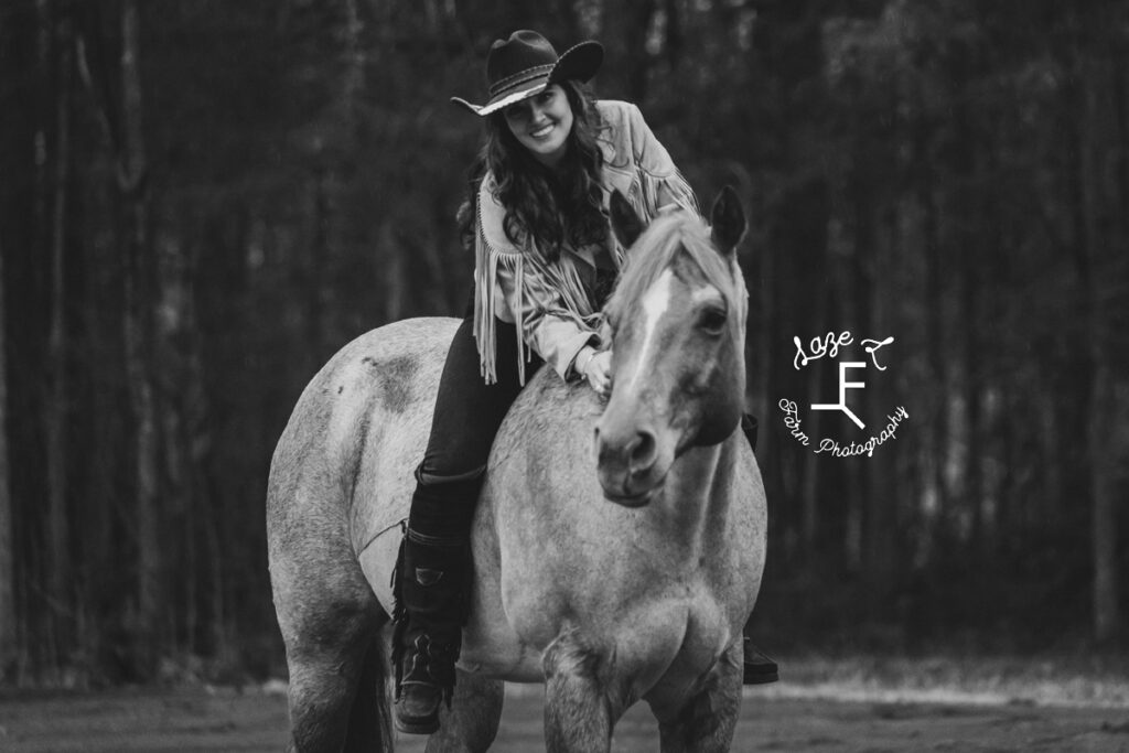 Amy on red roan horse in black and white