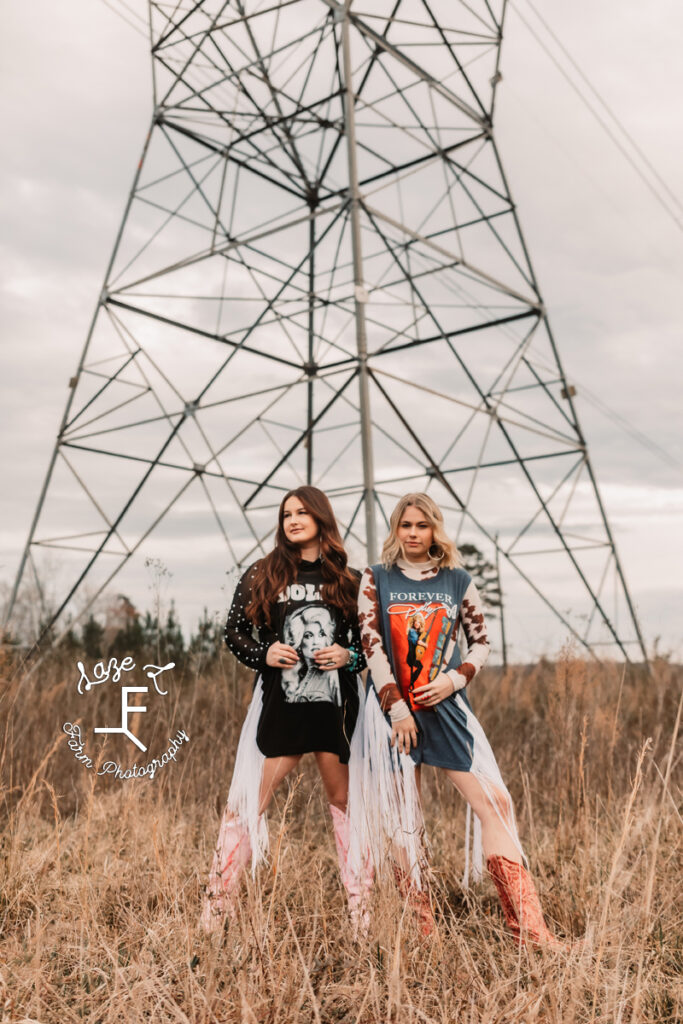 Savannah and Reid standing in front of powerline tower