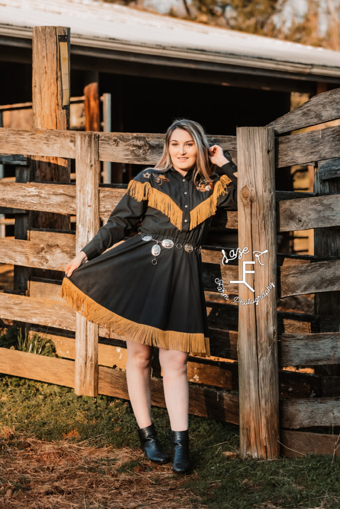 Calista in Blue and Gold vintage fringe dress at fence