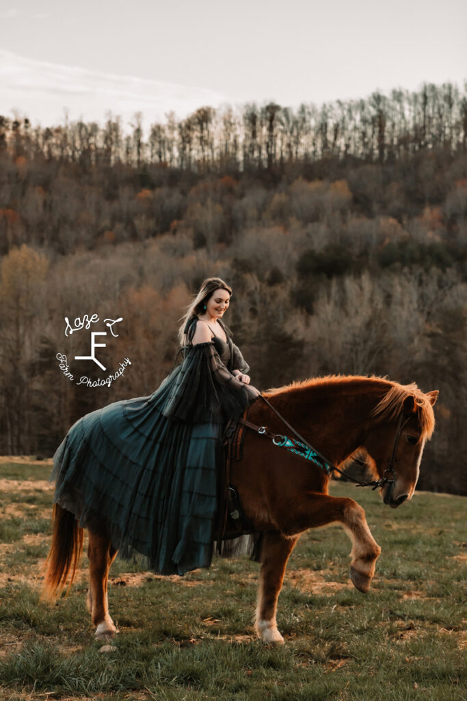 Calista in black dress riding Gus