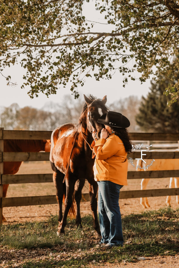 Kody loving her mare in an orange shirt