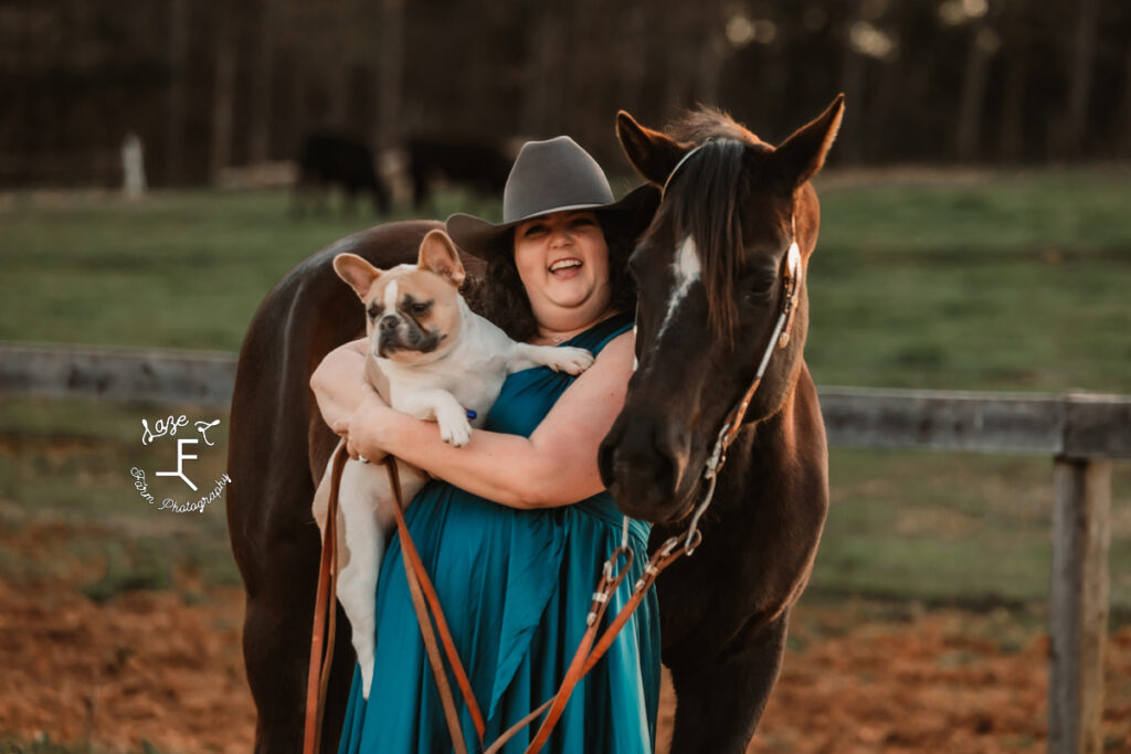 Kody holding dog with her mare laughing