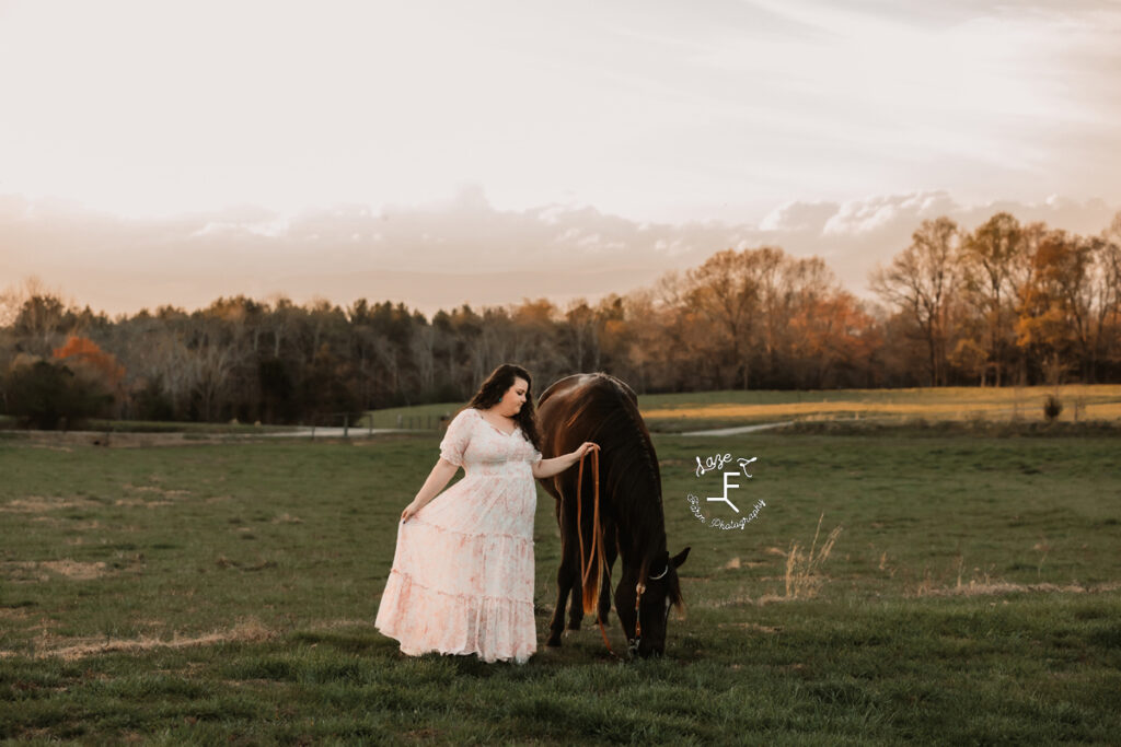 Kody in a white dress in a field at sunset