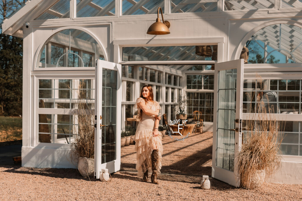 Bella in vintage lace standing outside greenhouse