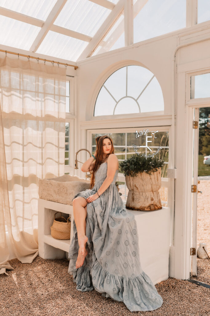 Bella in blue lace dress sitting on sink station