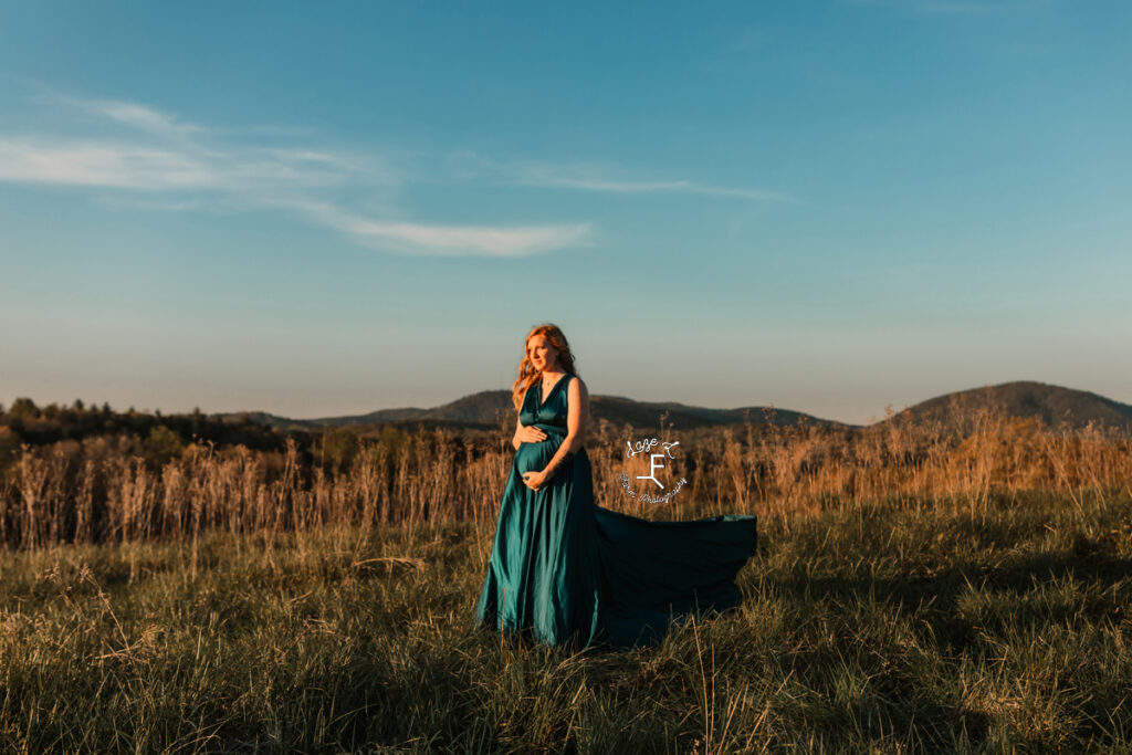 Alex standing with dress flowing looking away