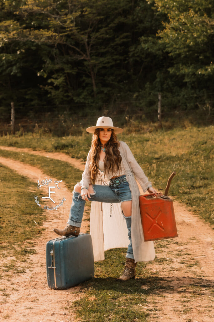 Wendy standing with gas can and suitcase