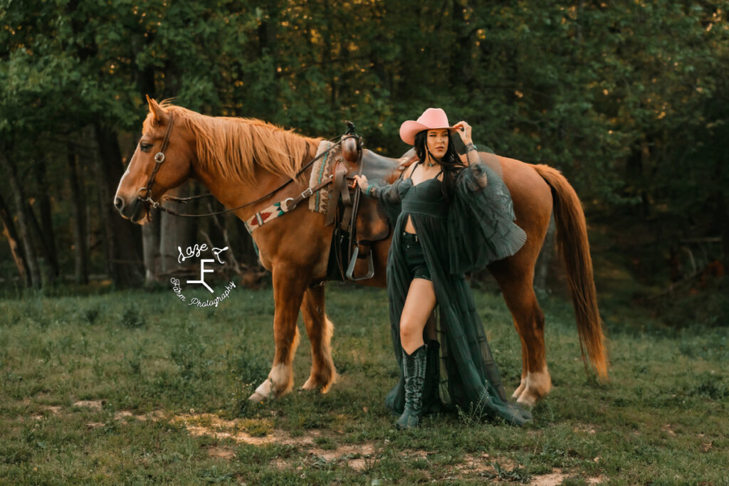 Halle in pink hat and black outfit standing with Gus