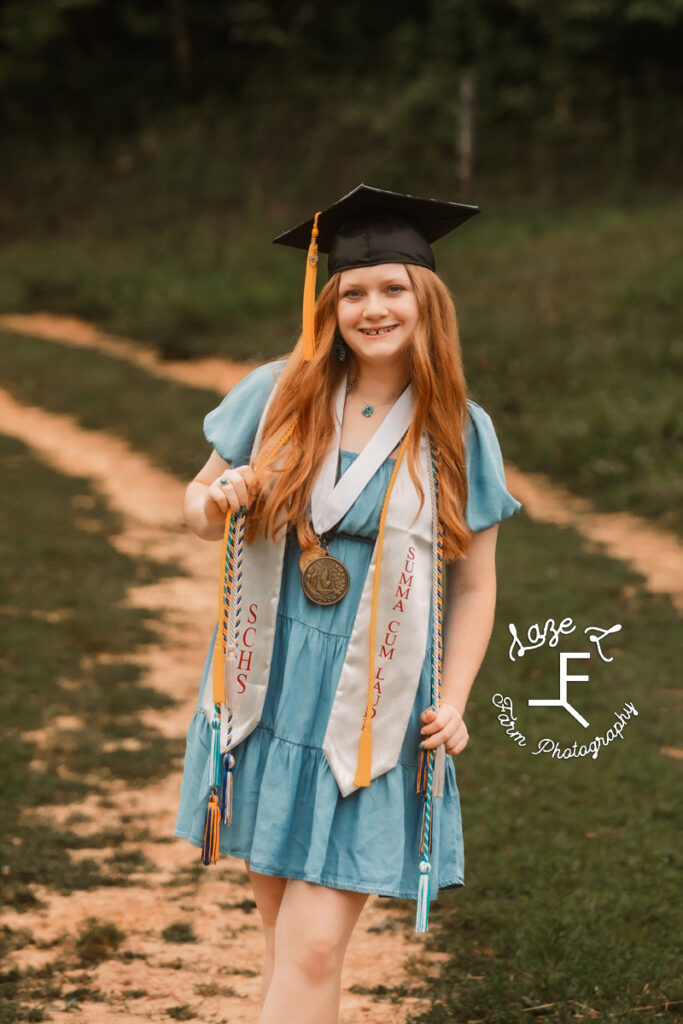 Bailey in her cap with her awards