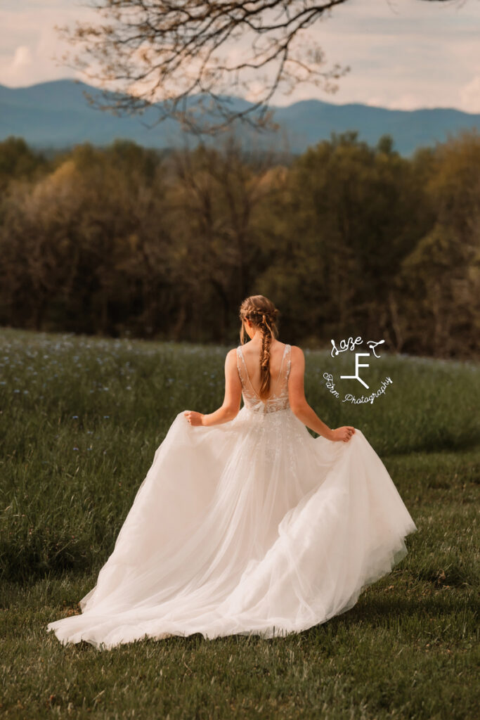 Gabbi in wedding dress in front of field