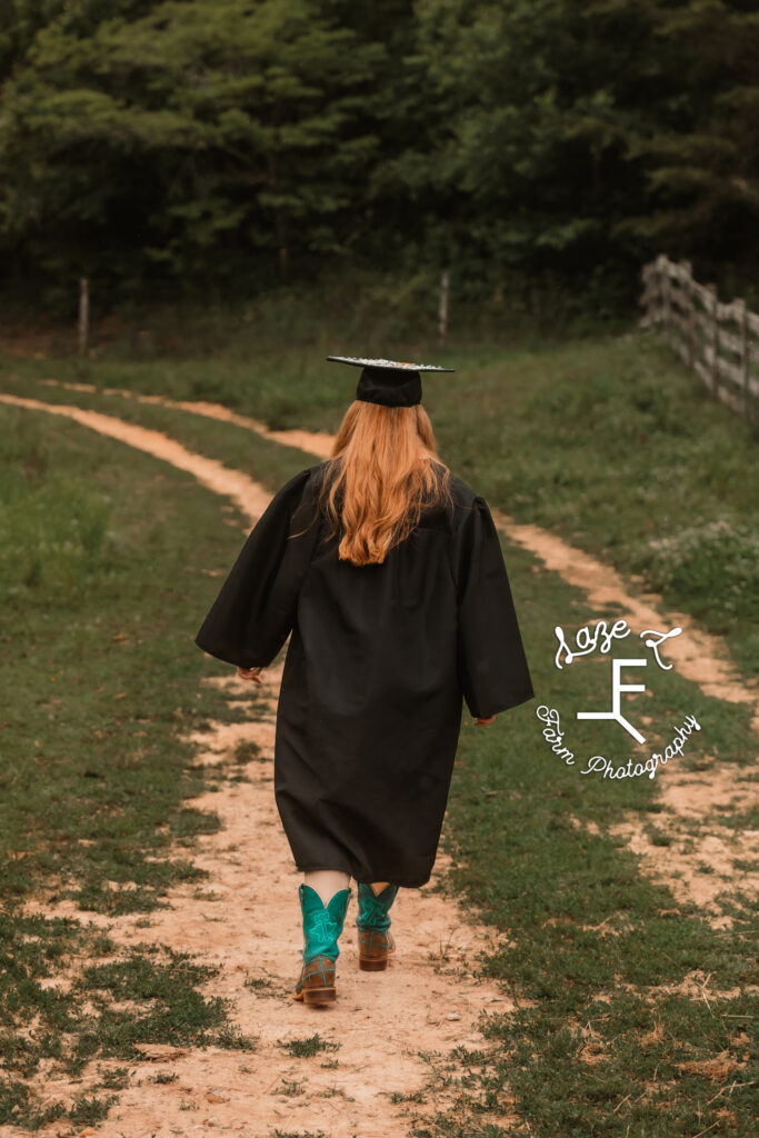 Bailey walking away in cap and gown