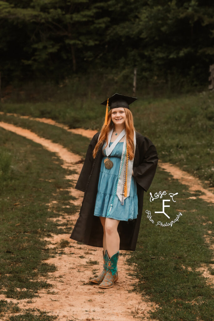 Bailey in blue dress and cap and gown