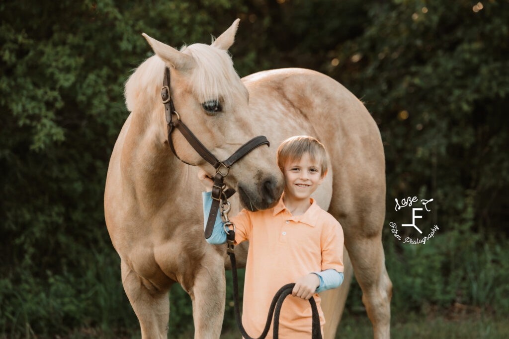 little boy with palomino horse