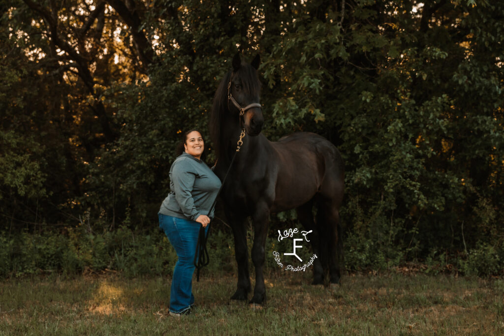 Lady in green shirt with black horse