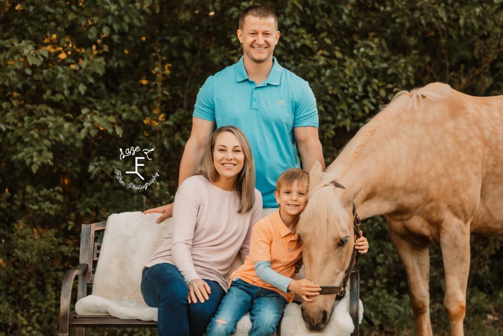 mom, dad and son with palomino horse