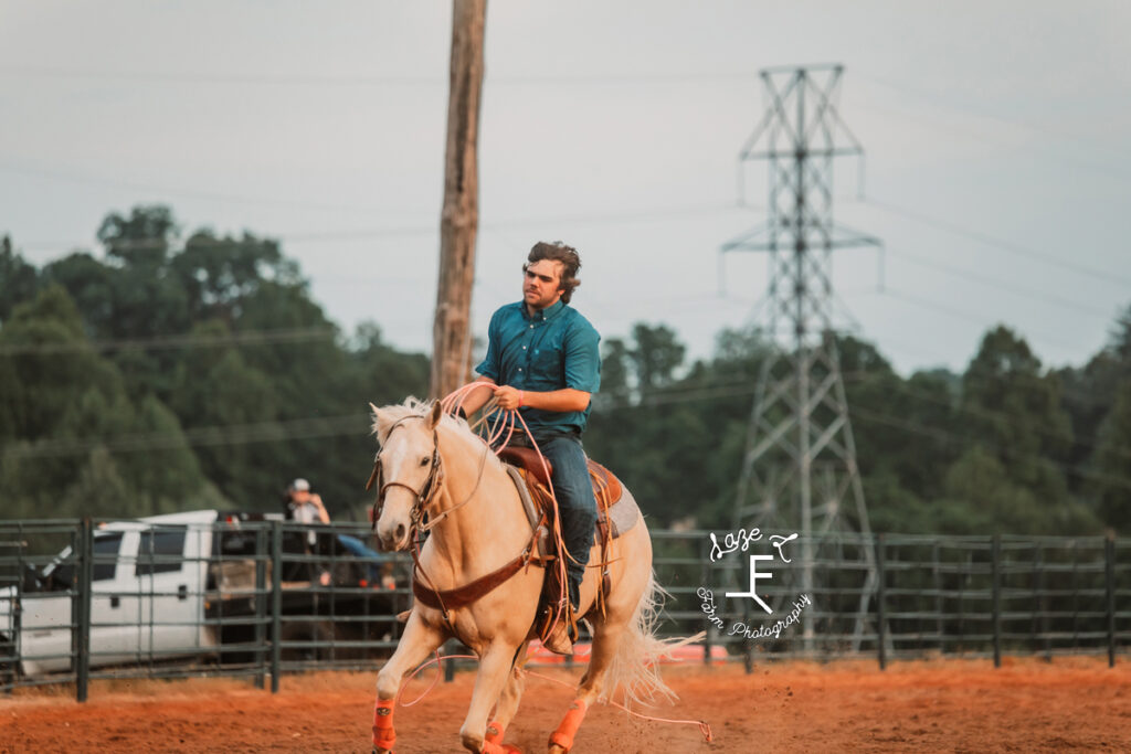 Team roper on Palomino horse