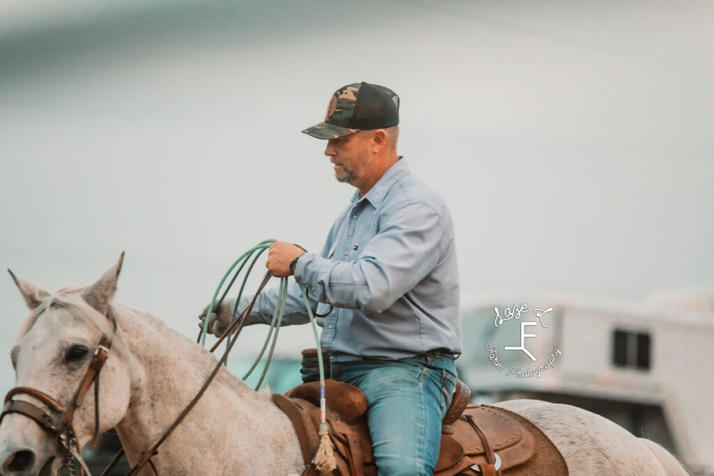 Team roper on his gray horse