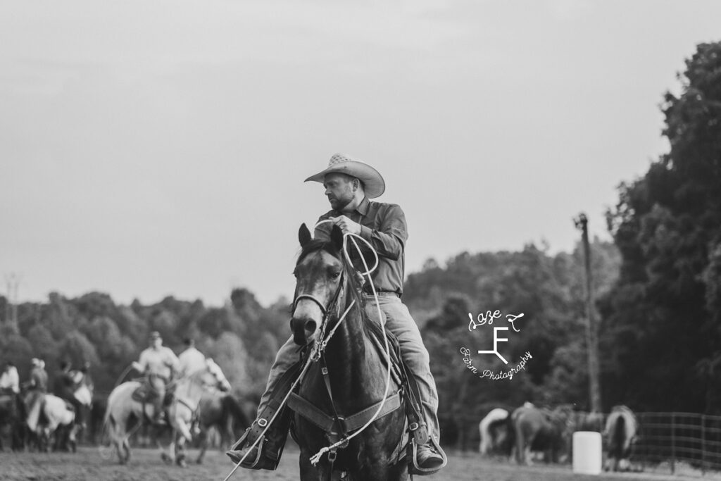 Team roper on horse in black and white