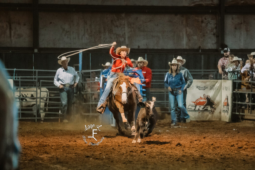 Breakaway roper on brown horse