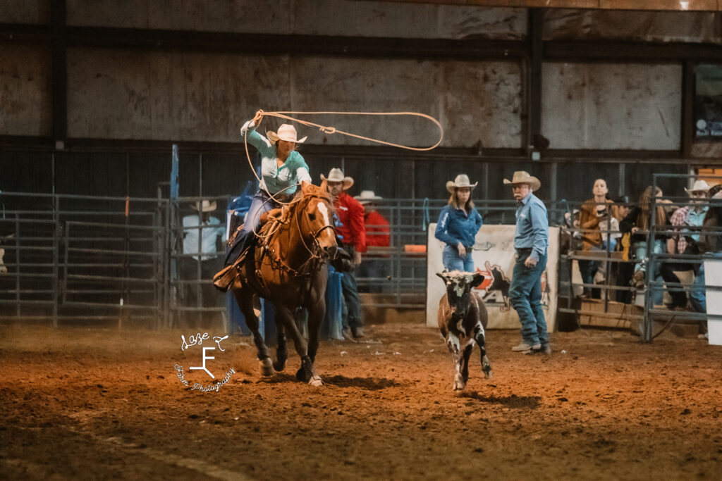 Breakaway roper on red horse