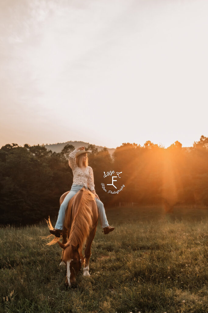 cowgirl on a horse at sunset