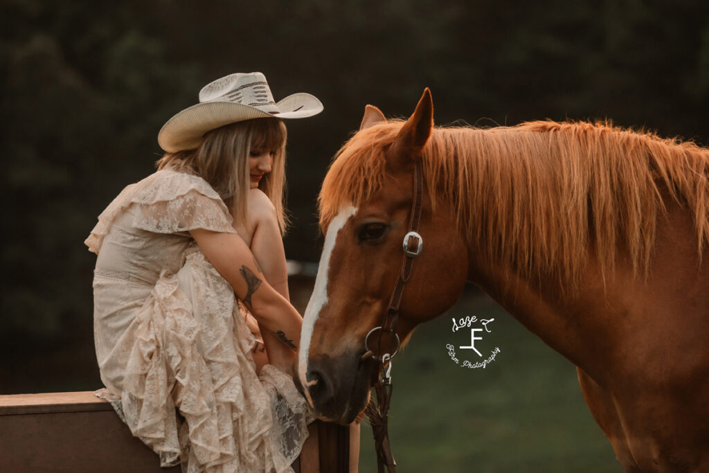 cowgirl petting her horse