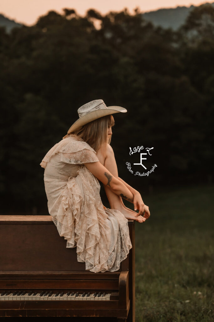 cowgirl sitting on a piano