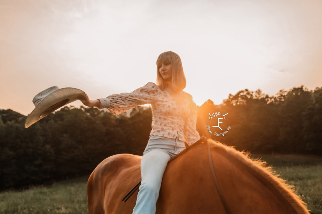 cowgirl on a horse at sunset