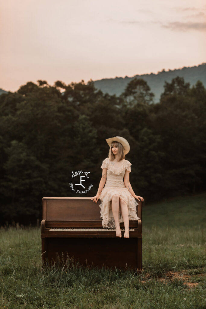 cowgirl sitting on a piano