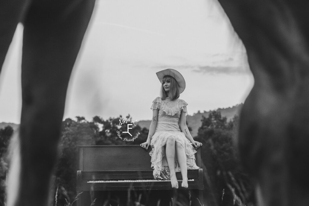 cowgirl sitting on a piano