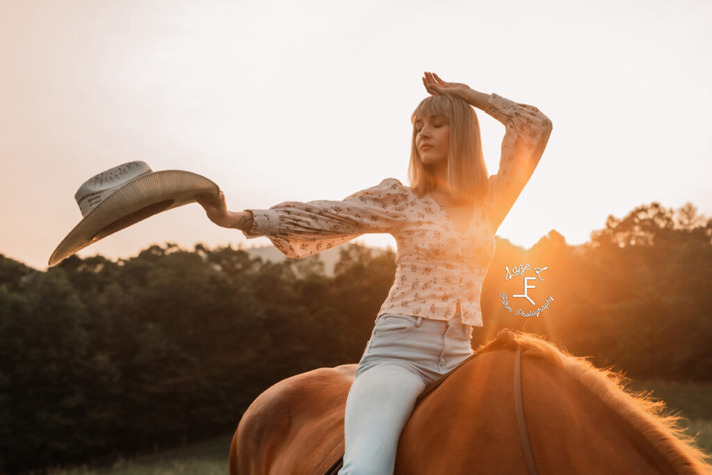 cowgirl on a horse at sunset