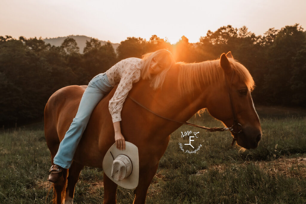 cowgirl on a horse at sunset