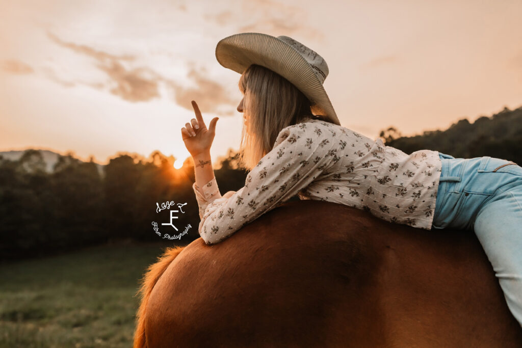 cowgirl on a horse at sunset