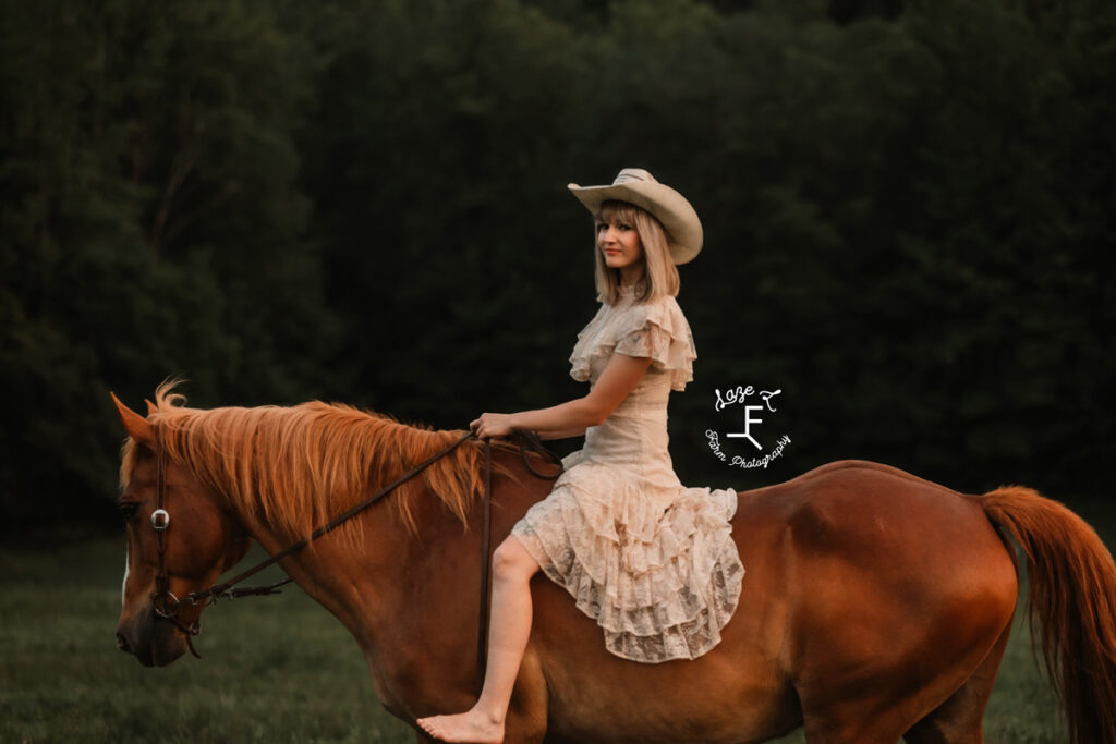 cowgirl on a horse at sunset