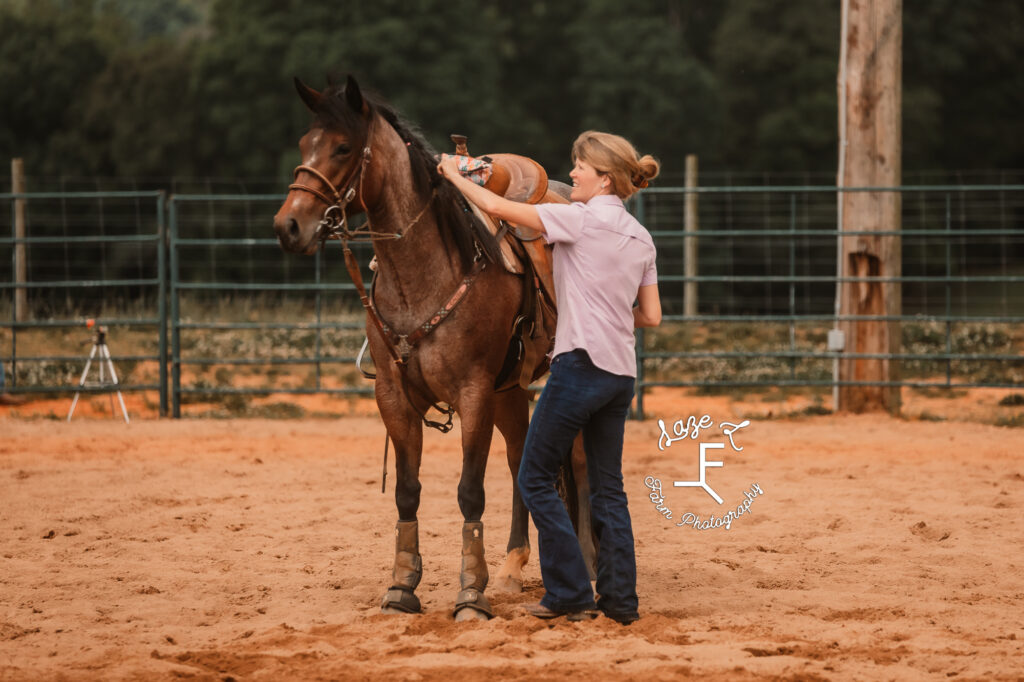 Cowgirl working with horse in the arena