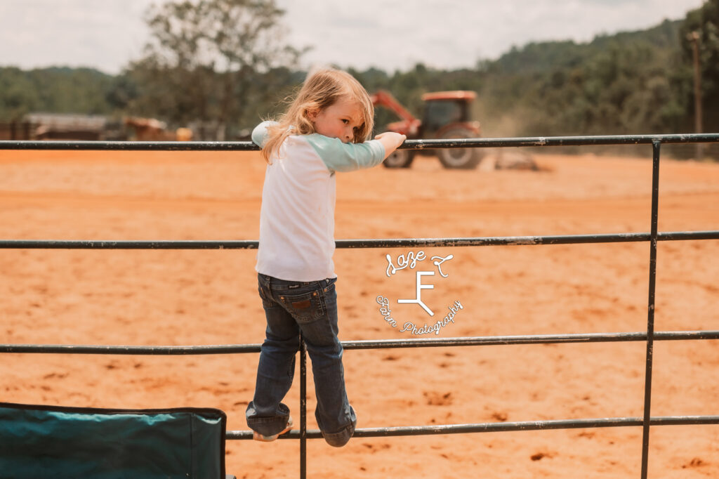 little girl climbing the fence