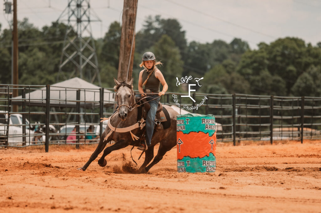 grey horse and cowgirl running barrels